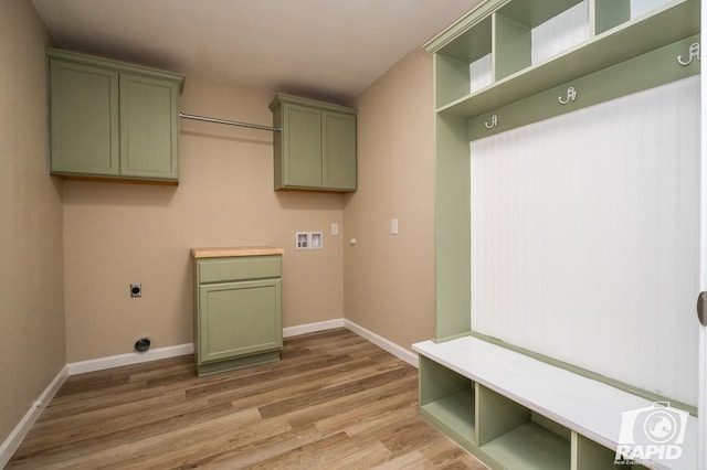 laundry area featuring hookup for a washing machine, hookup for an electric dryer, cabinets, and light hardwood / wood-style floors