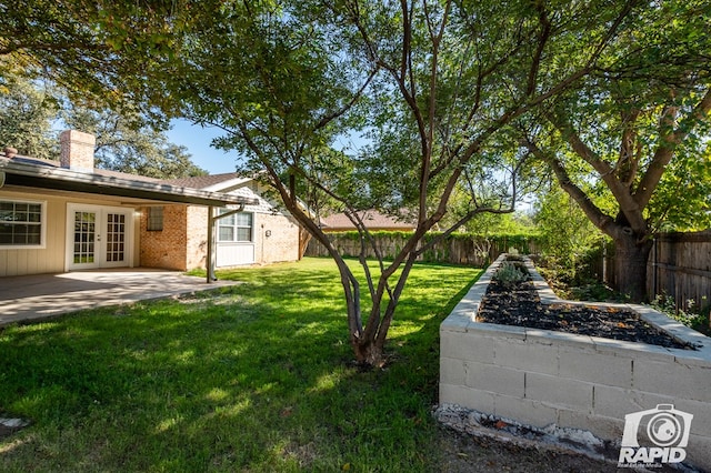 view of yard with a patio and french doors