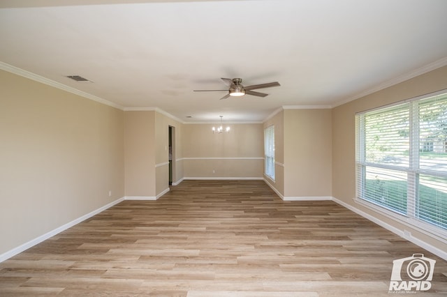 empty room featuring ornamental molding, ceiling fan with notable chandelier, and light hardwood / wood-style flooring