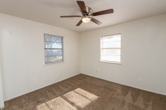 carpeted spare room with ceiling fan