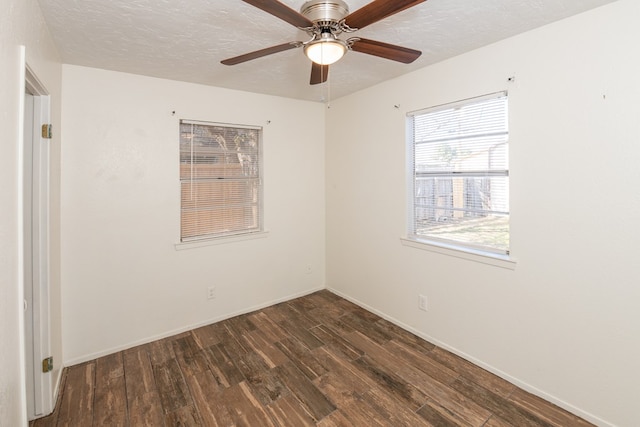 unfurnished room with ceiling fan, dark hardwood / wood-style floors, and a textured ceiling