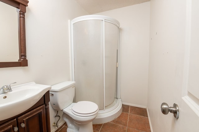 bathroom with vanity, toilet, a textured ceiling, and walk in shower