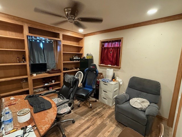 office featuring ceiling fan, ornamental molding, and wood finished floors