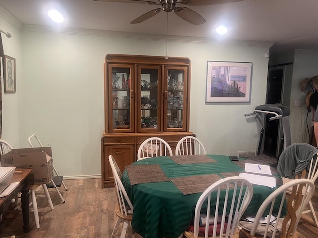 dining area featuring hardwood / wood-style flooring, ornamental molding, and ceiling fan