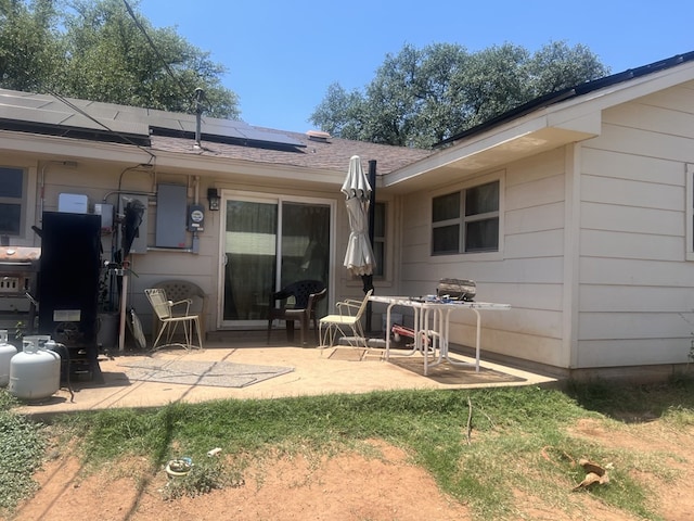 back of house featuring a patio and solar panels