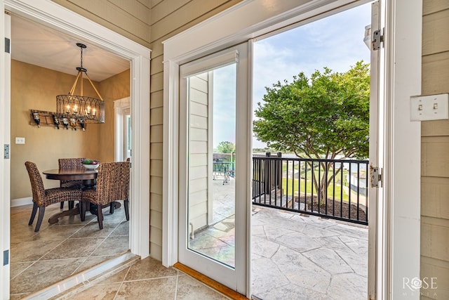 3045 Red Bluff Cir, San Angelo, TX 76904 - doorway with a chandelier and stone finish flooring
