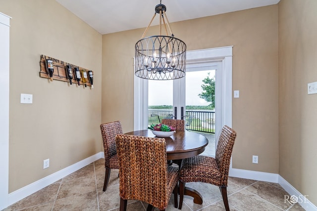 3045 Red Bluff Cir, San Angelo, TX 76904 - dining area with a chandelier, baseboards, and tile patterned floors