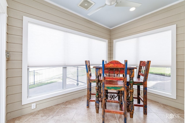 3045 Red Bluff Cir, San Angelo, TX 76904 - tiled dining space with ceiling fan, recessed lighting, ornamental molding, and wood walls