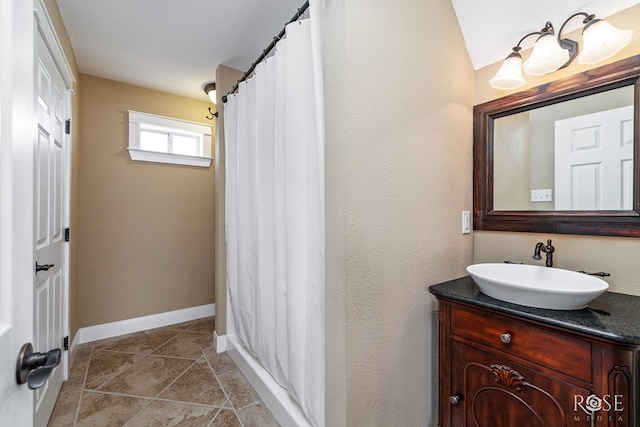 3045 Red Bluff Cir, San Angelo, TX 76904 - full bathroom featuring vanity, baseboards, and stone finish floors