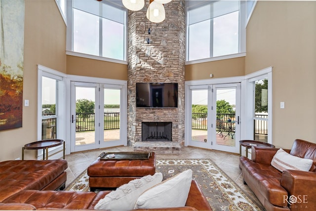 3045 Red Bluff Cir, San Angelo, TX 76904 - living room with a high ceiling, tile patterned floors, and a stone fireplace