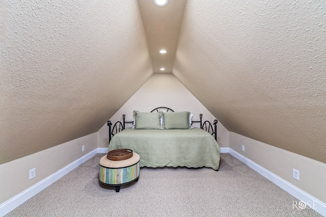 3045 Red Bluff Cir, San Angelo, TX 76904 - bedroom featuring a textured ceiling, recessed lighting, vaulted ceiling, baseboards, and carpet