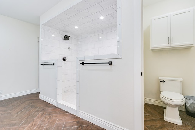 full bath with toilet, baseboards, and a walk in shower