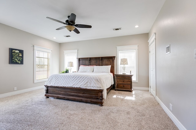 carpeted bedroom featuring recessed lighting, visible vents, ceiling fan, and baseboards