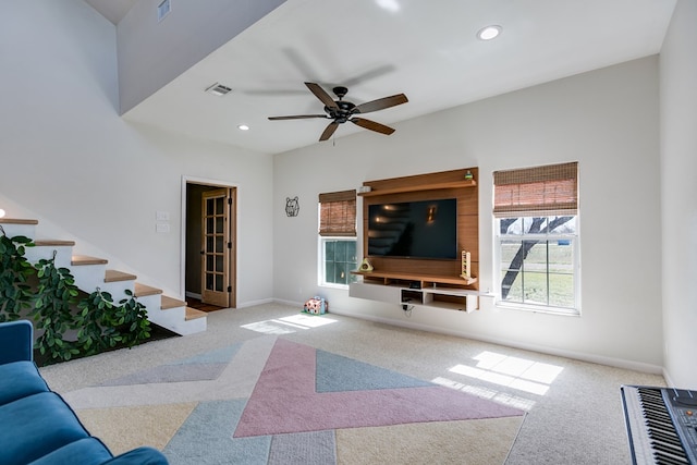 living room featuring carpet floors, baseboards, stairway, and recessed lighting