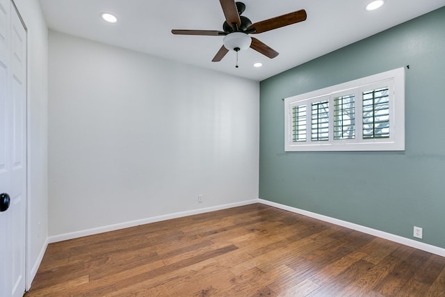 unfurnished room with ceiling fan, recessed lighting, wood finished floors, and baseboards