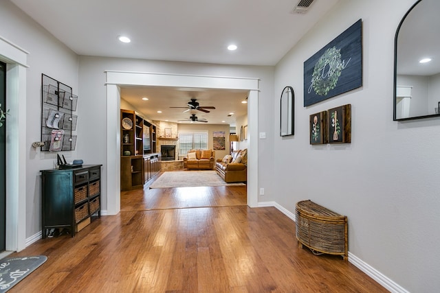 interior space featuring recessed lighting, baseboards, visible vents, and hardwood / wood-style floors