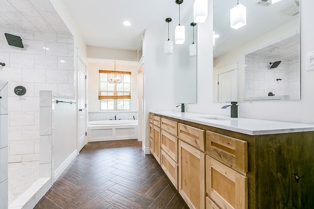 bathroom featuring a chandelier, a garden tub, a sink, tiled shower, and double vanity