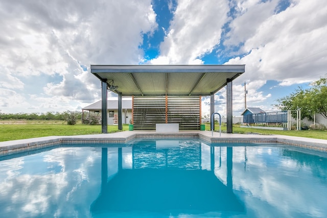 outdoor pool with a yard