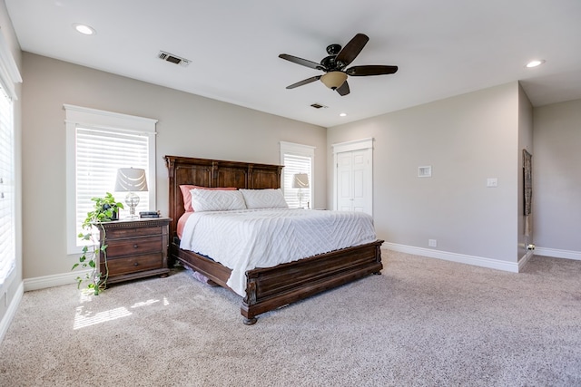 carpeted bedroom featuring recessed lighting, visible vents, and baseboards