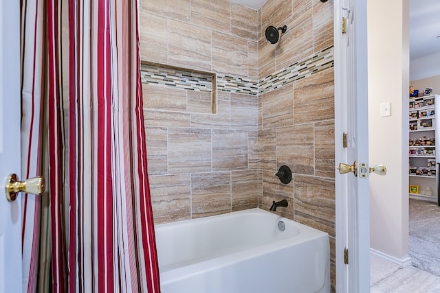 full bath with baseboards and shower / tub combo with curtain