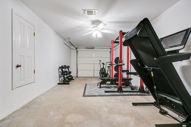 exercise room featuring a garage, visible vents, and a ceiling fan