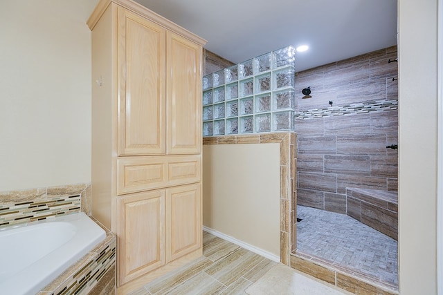 full bath featuring a walk in shower and a garden tub