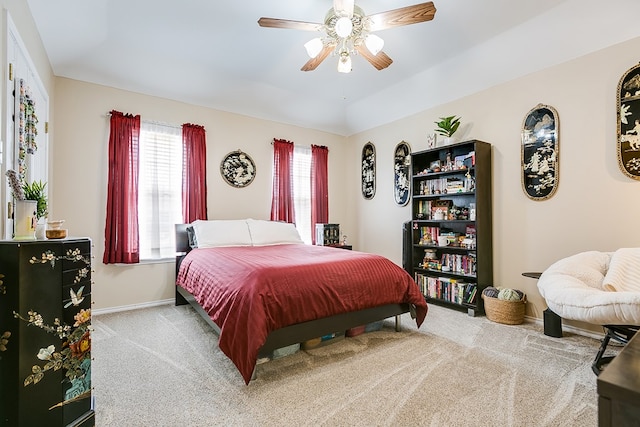 bedroom featuring a ceiling fan, carpet, lofted ceiling, and baseboards