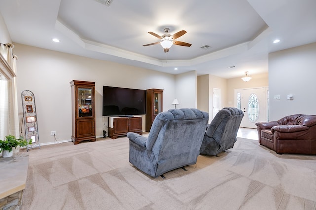 living room with baseboards, visible vents, a raised ceiling, light colored carpet, and recessed lighting