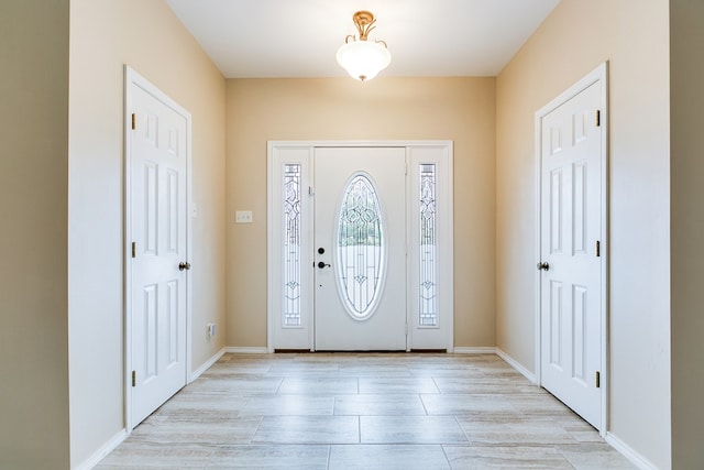 entryway featuring baseboards