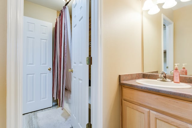 bathroom with wood finished floors and vanity