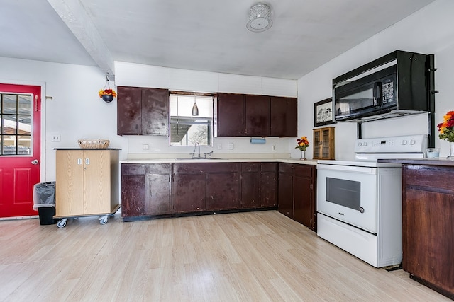 kitchen with dark brown cabinets, sink, white electric range oven, and light wood-type flooring