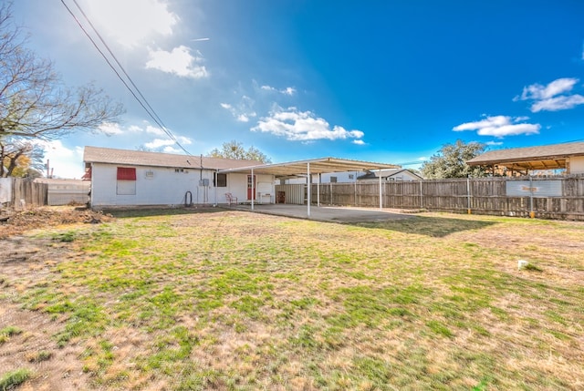 back of property with a patio area and a lawn