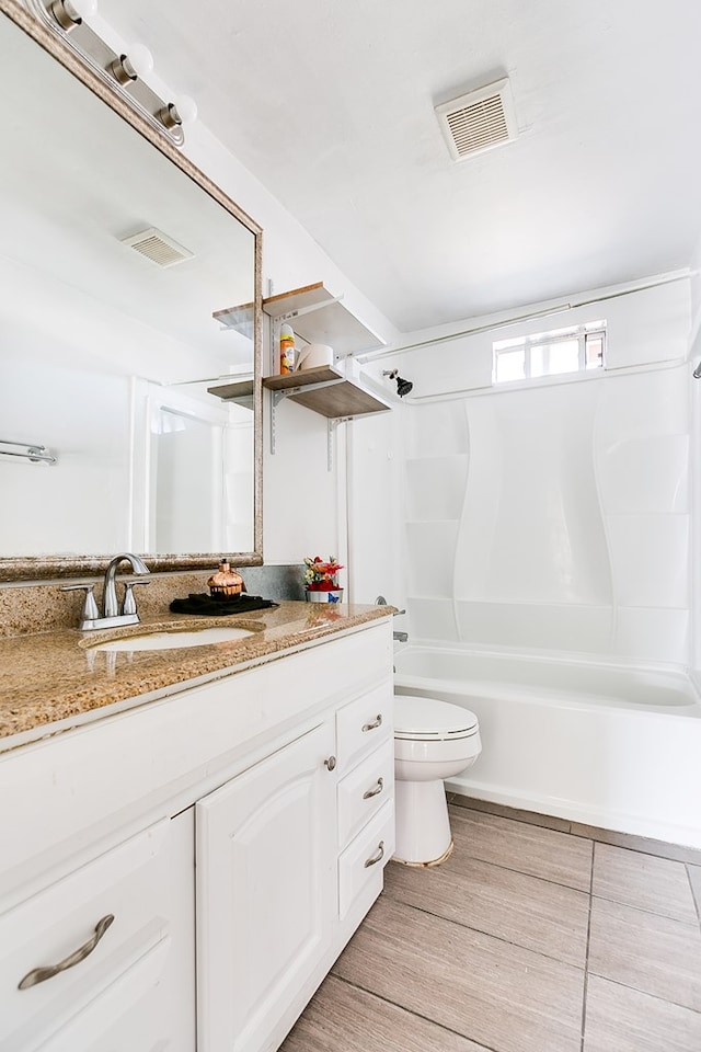 full bathroom featuring shower / bathtub combination, vanity, and toilet