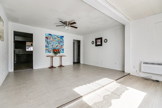 unfurnished room with wood-type flooring, an AC wall unit, and ceiling fan