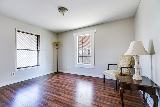 sitting room with dark hardwood / wood-style flooring and a wealth of natural light