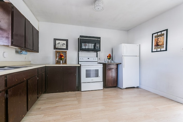 kitchen with sink, backsplash, light hardwood / wood-style floors, dark brown cabinets, and white appliances