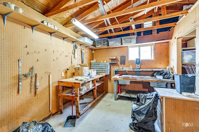 interior space with lofted ceiling with beams and a workshop area