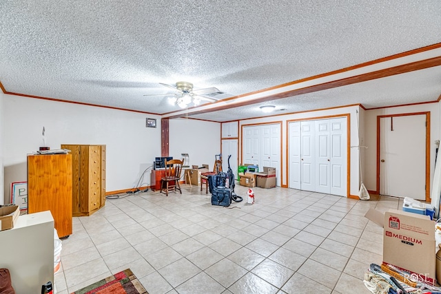 interior space with ceiling fan, ornamental molding, and a textured ceiling