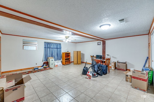 interior space featuring ceiling fan, ornamental molding, and a textured ceiling