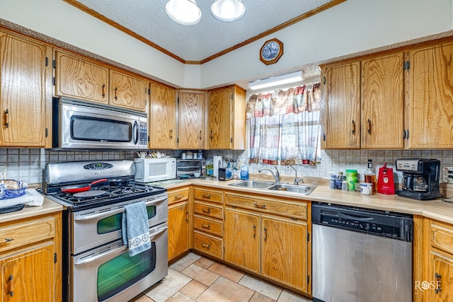 kitchen with stainless steel appliances, sink, a textured ceiling, and decorative backsplash