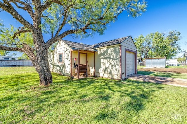 view of outbuilding featuring a garage and a yard