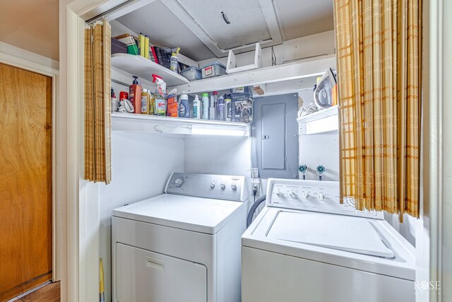 clothes washing area with washer and clothes dryer and electric panel