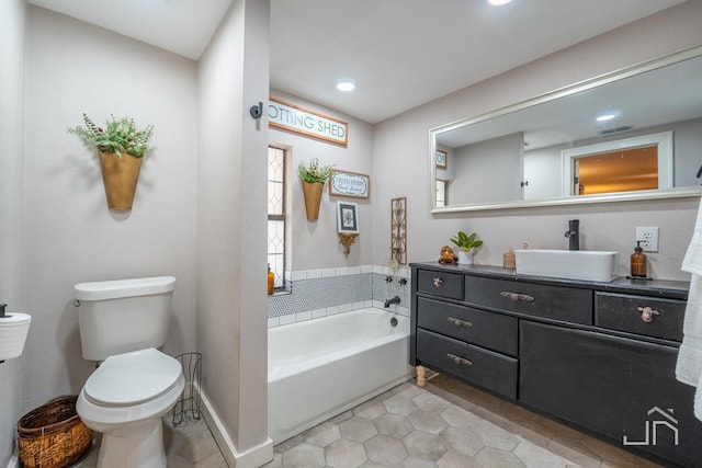 bathroom featuring tile patterned floors, visible vents, a garden tub, toilet, and vanity