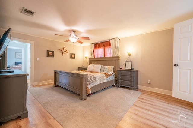 bedroom with visible vents, light wood-style flooring, baseboards, and ceiling fan