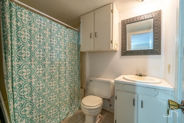 bathroom featuring tile patterned flooring, a textured ceiling, toilet, and vanity