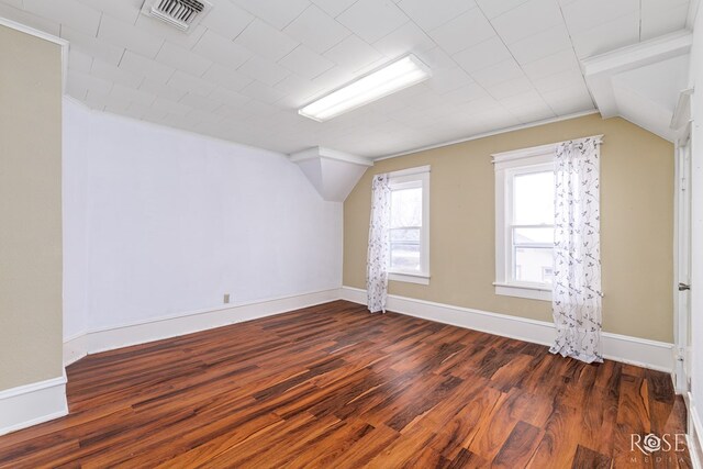 bonus room featuring dark hardwood / wood-style flooring and vaulted ceiling