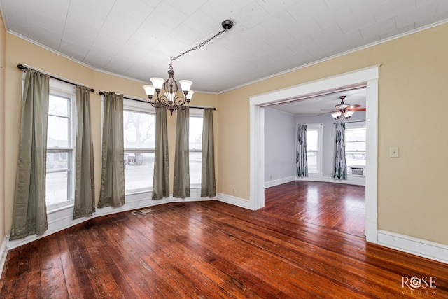 empty room with hardwood / wood-style flooring, ornamental molding, and ceiling fan with notable chandelier