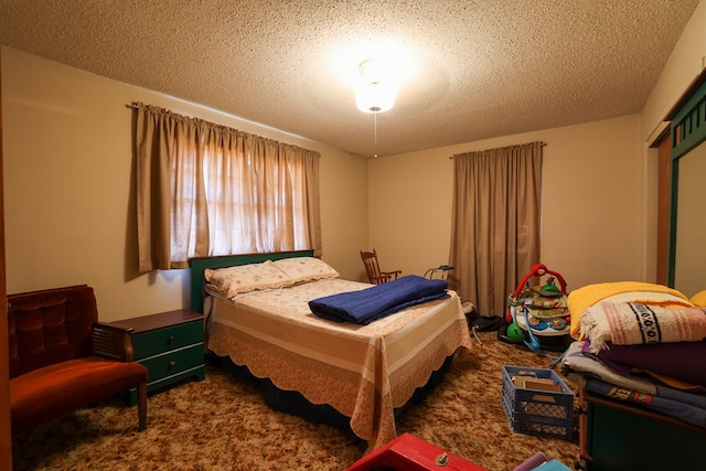 bedroom featuring carpet floors and a textured ceiling