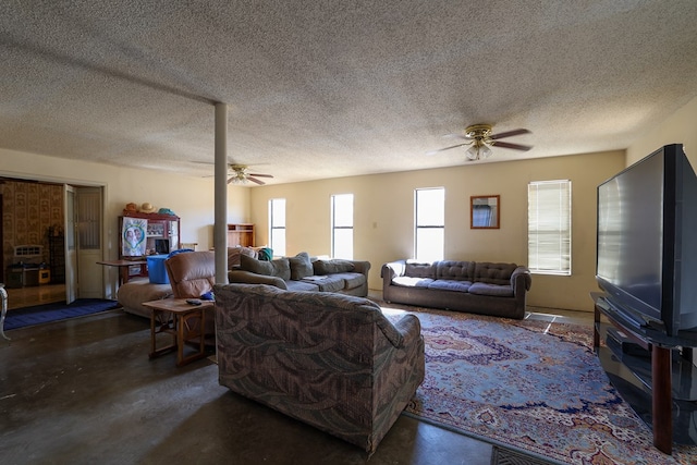 living room with ceiling fan and a textured ceiling