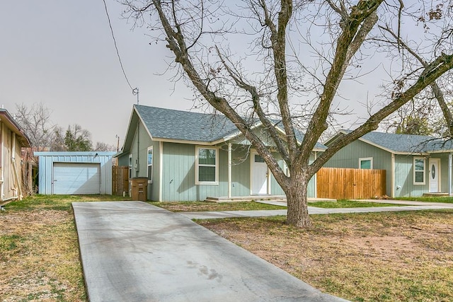 view of front of house with a shingled roof and fence